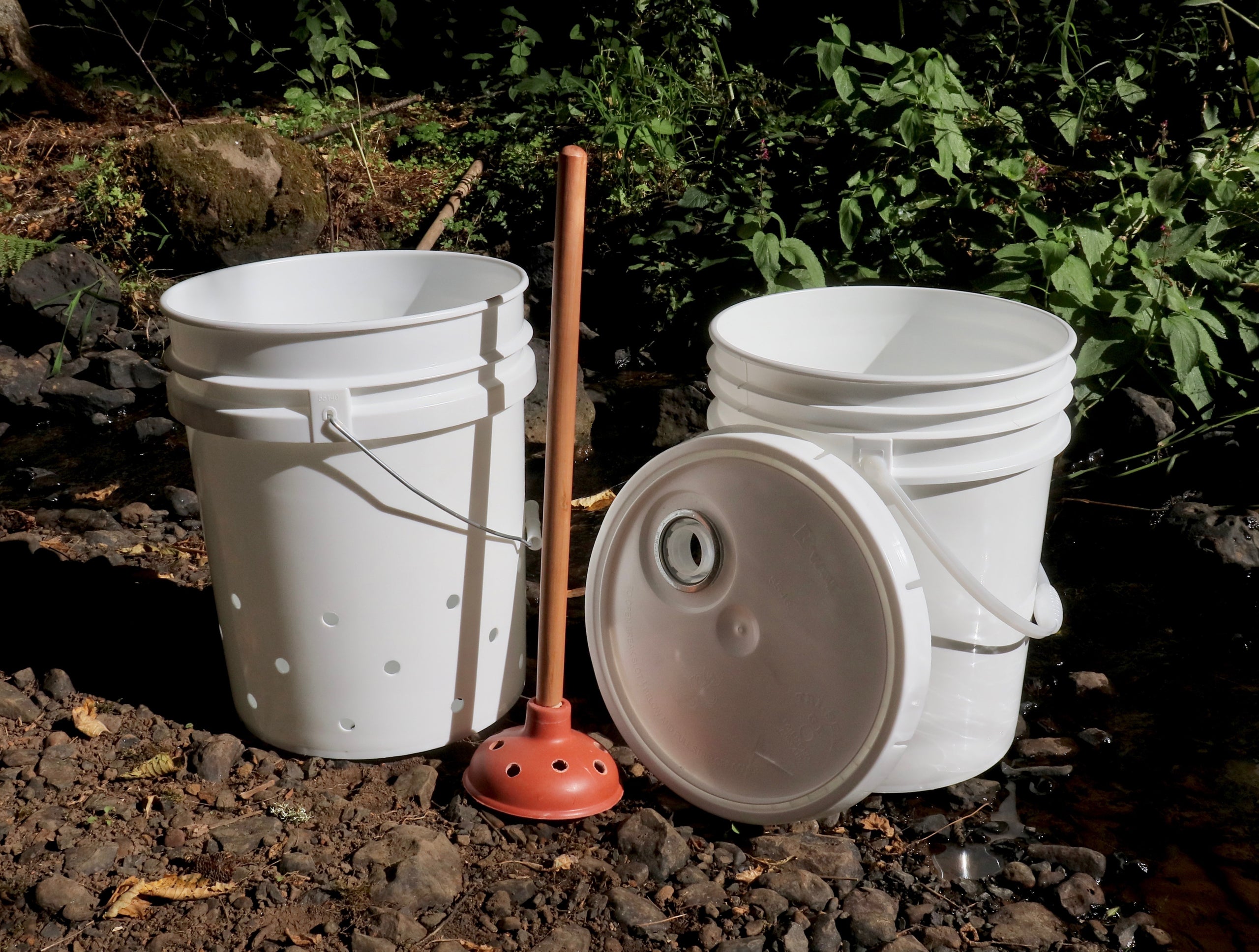 Make a camp washing machine using bucket and plunger